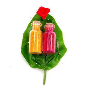 Traditional Haldi Kumkum Bottles on Decorative Leaf Base